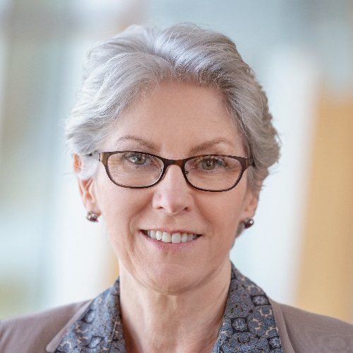 Portrait of senior Caucasian businesswoman standing at office lobby wearing eyeglasses